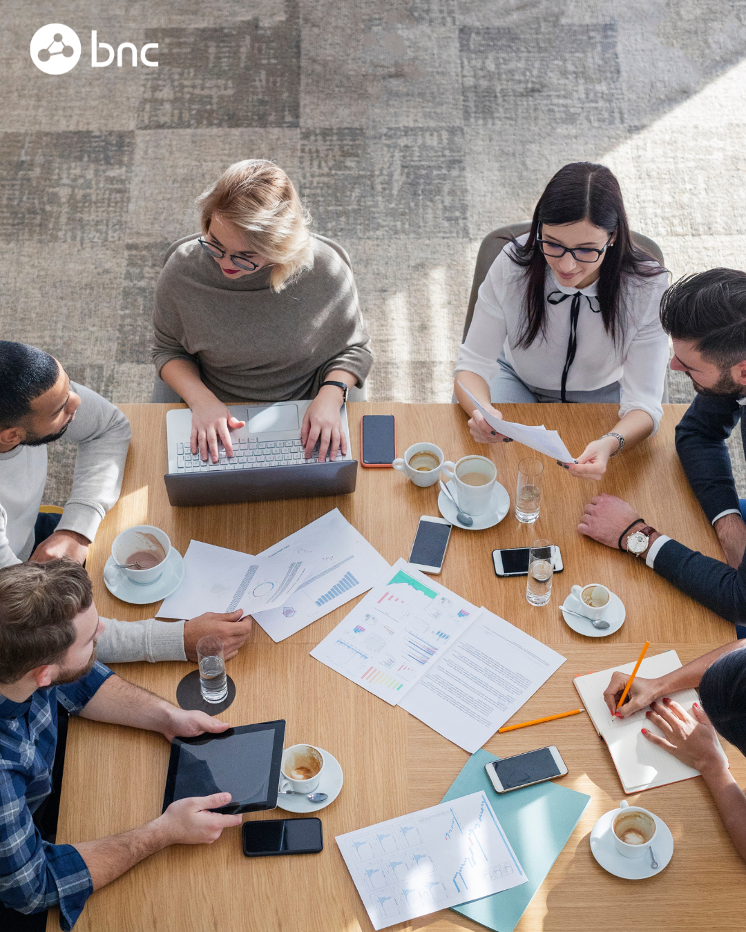 Group in meeting with computers